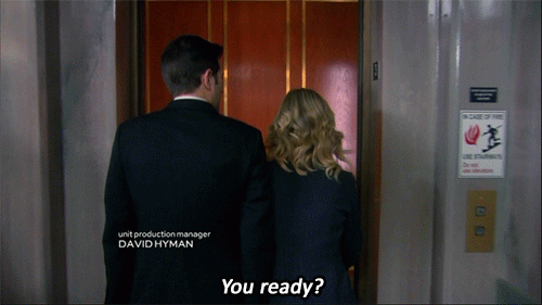 Adam Scott as Ben Wyatt and Amy Poehler as Leslie Knope in an episode of Parks and Recreation, entering an elevator before the doors close, with captions «You ready?» «Not at all. But that’s never stopped us before.»